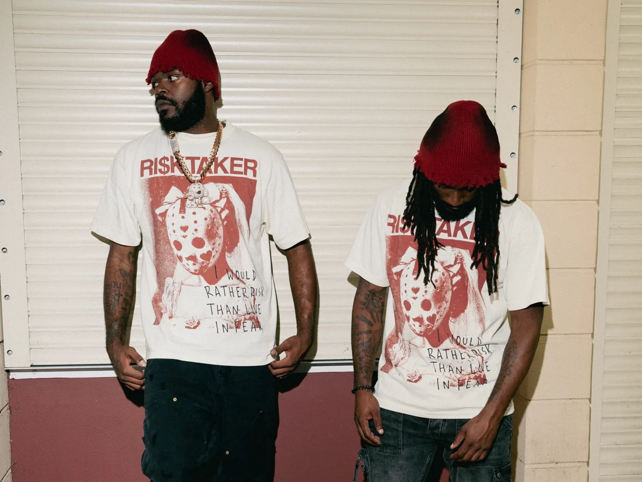 RI$KTAKER founder on the left wearing the Mask Tee with another model, showing two different fits