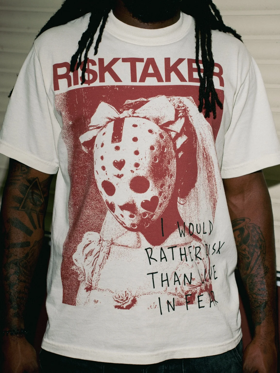 Close-up of the actual RI$KTAKER Mask Tee oxblood graphic and screen print texture